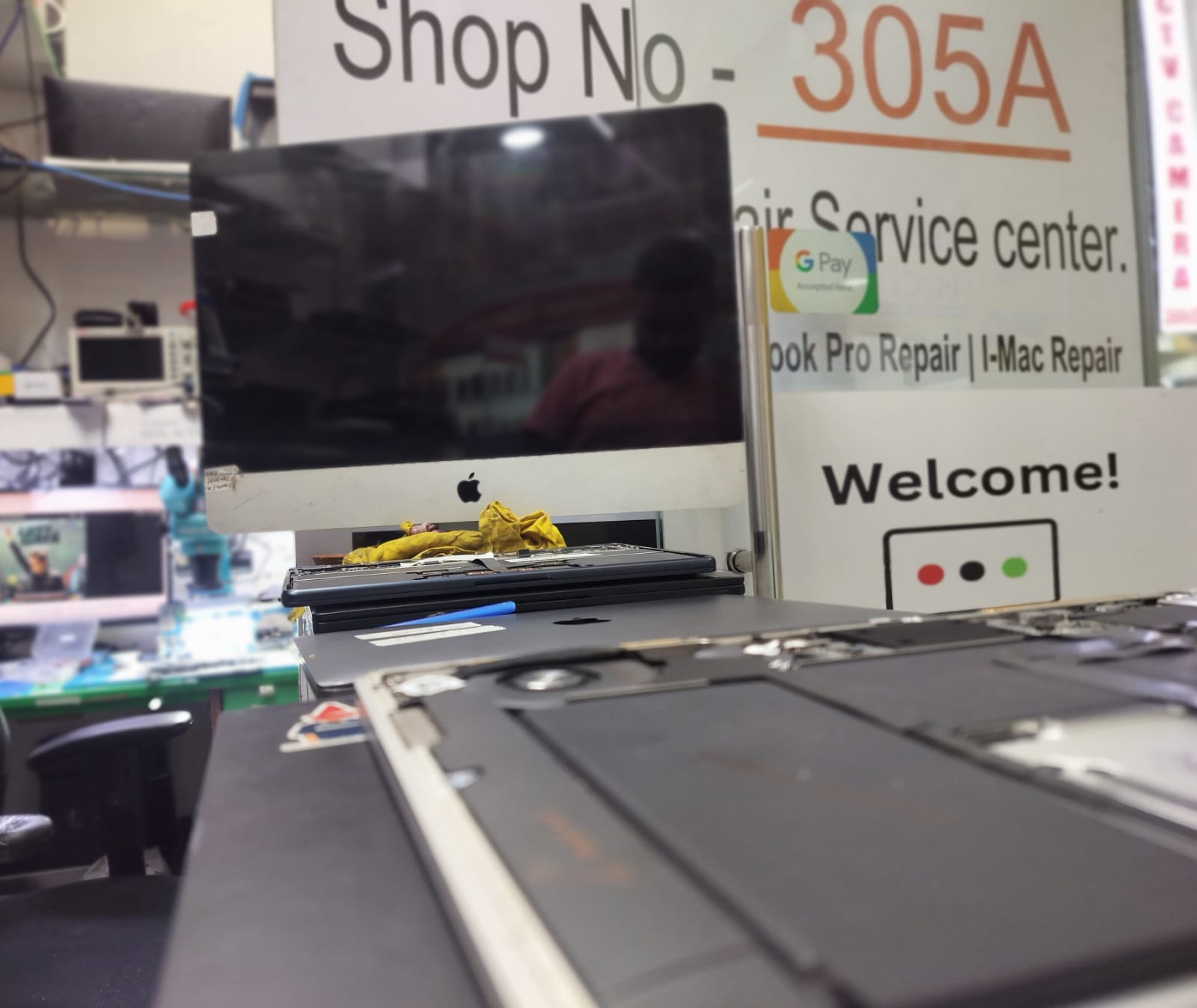 iMac and open MacBook placed at the CompSense workshop desk